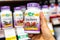 Shoppers hand holding a plastic bottle of Nature`s Way cranberry vegetarian capsules