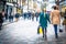 Shoppers hold hands on busy London high street