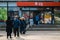 Shoppers stand in line and wait to get to the store given the constraints of the Covid-19 pandemic