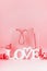 Shopping bag with red stripes , word LOVE and nice decoration at red background, front view. Copy space