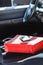 Shopping bag and smartphone lying on car seat