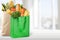 Shopping bags with grocery products on wooden
