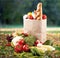 Shopping bags with grocery products on wooden