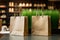 Shopping bags made from craft paper full of green grass with copy space