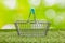 Shopping basket on a background of natural greenery, Creative, Concept, Responsible shopping with care for the environment, Empty