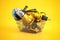 Shopping basket with elecric tools and construction equipment angle grinder, electric drill and jigsaw on yellow. Selling and