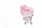 shopping basket with a large heart-shaped gift and a pink bow on a white background