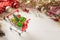 Shopping cart with christmas tree and miniature gift boxes on white wooden table. Christmas and New Year shopping time background