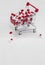 Shopping cart filled with medical capsules,pills,medication,drugs on white background top view with copy space, medicine,