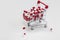 Shopping cart filled with medical capsules,pills,medication,drugs on white background top view with copy space, medicine,