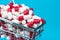 Shopping cart filled red medicinal capsules