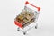 Shopping cart full of money with chain and padlock on white background - Concept of saving and security, purchasing crisis