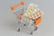 Shopping cart with medical supplies on gray