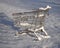 Shopping cart from the supermarket in the snow. The concept of closed stores, low demand, crisis, corontin. Consumer winter