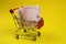 Shopping cart with Ukrainian money, hryvnia. Paper money, small bills