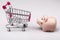 Shopping cart versus pig money box