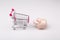 Shopping cart versus pig money box