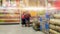 Shopping cart view in Supermarket aisle with Product shelves abstract blurred.