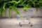 Shopping concept, Mini trolley and wooden block in outdoor garde