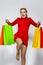 Shopping Concepts. Portrait of Young Caucasian Exclaiming Girl  Posing With Plenty of Colorful Shopping Bags Against White