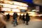 Shopping crowd walking on sidewalk at dusk