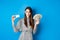 Shopping. Elegant sassy woman with dollar bills money and plastic credit card, looking confident at camera, blue