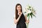 Shopping, employees and small business concept. Smiling pretty saleswoman florist in flower shop holding bouquet of