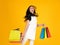 Shopping event of Cyber Monday Sale with Caucasian adult woman jump and hold colorful paper bags for mock up branding portrait