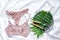 Shopping and fashion concept. Set of glamorous stylish lace lingerie lying on bed with green leaves. Woman clothes and access