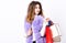 Shopping and gifts. Fashionista buy clothes on black friday. Girl makeup furry violet vest shopping white background