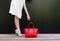 Shopping. girl pulls her hand to the bag. fashion girl in a short white dress in beautiful shoes with ribbons and large