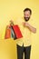 Shopping happiness. Man emotional enjoying shopping. Bearded mature man with shopping bag on yellow background. Sale and