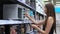 Shopping in hardware store, woman is choosing microwave oven