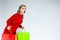 Shopping Ideas and Concepts. Portrait of Surprised Caucasian Girl  Posing With Plenty of Colorful Shopping Bags Against White