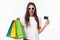 Shopping, leisure and lifestyle concept. Lets weekend and vacation begin. Sassy young girl in sunglasses with shop bags