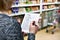 Shopping list in hands of woman in supermarket