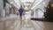 Shopping mall with defocused walking peoples