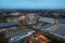 Shopping malls, roads and logistics warehouses illuminated by bright lights at night, top view. Wroclaw Poland