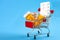 Shopping for medicines, healthcare costs and prescription medication concept with a shopping cart or trolley filled with pills