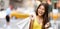 Shopping in New York City Asian woman smiling happy holding shopping bags panoramic banner. Girl buying fashion clothing