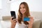 Shopping and relax at home. Portrait of young woman enters her credit card number on smartphone for e-commerce