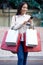 Shopping, retail and woman with phone in city for sale, discount and bargain notification. Fashion store, mall and happy