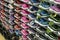 Shopping rows in shoes store. Multi-storey shelve with rows of kid colorful sneakers. Shoe