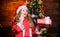 Shopping and sale. Festive atmosphere christmas day. Girl santa claus costume hold christmas gift box. Prepare surprise