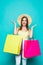 Shopping. Shopping woman excited dynamic image of young woman with shopping bags. on color background.