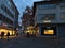 Shopping street KirchstraÃŸe in downtown with illuminated shop windows in the evening during Christmas season.