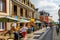 A shopping street with restaurants and terraces in the center of Saint Valery sur Somme.