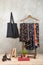 Shopping and style concept - clothes rack with trendy dresses in floral print, shoes and black eco tote bag on wooden floor and
