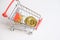 Shopping trolley cart with Coins bitcoin, buying goods for crypto currency.