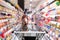 Shopping trolley in department store with goods shelf background